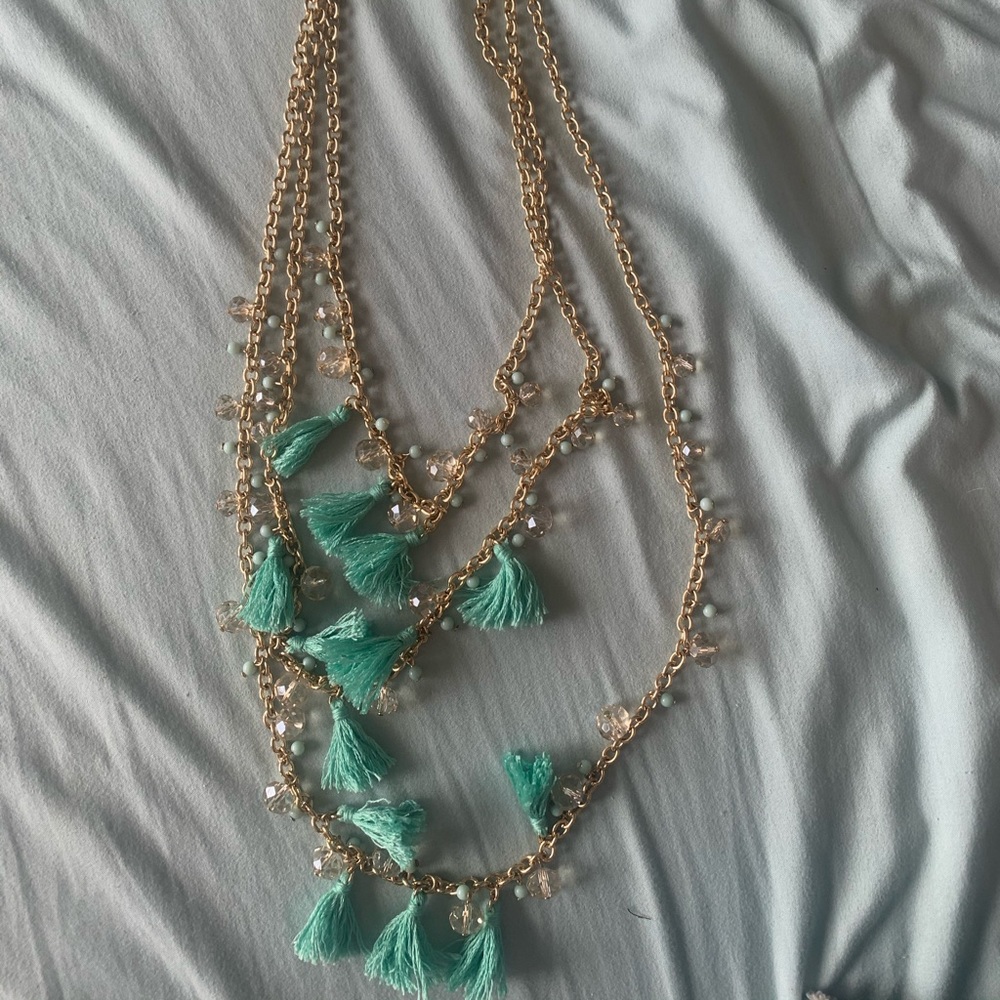 multiple layered gold chain and tassel necklace